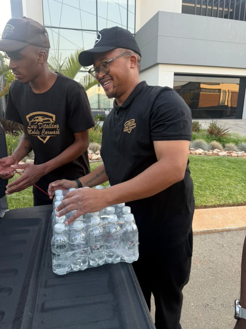 Luxe Detailing Mobile Carwash team receiving Mabatha sparkling water